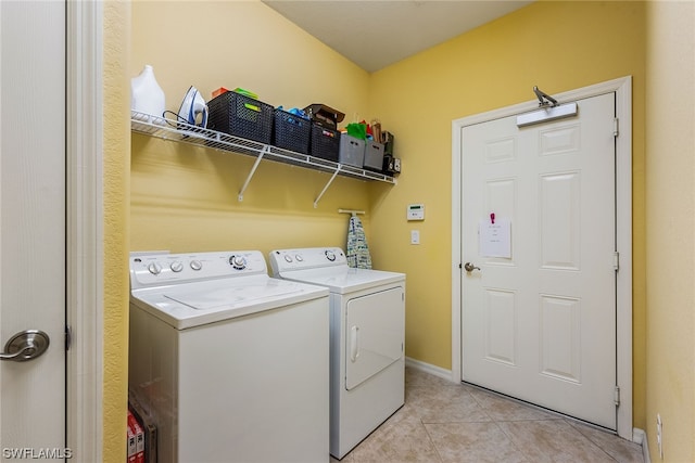 laundry room with separate washer and dryer and light tile floors