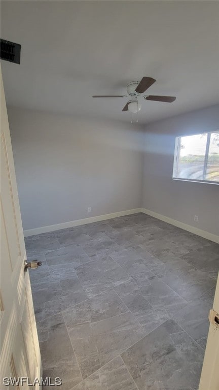 unfurnished room with ceiling fan and tile flooring