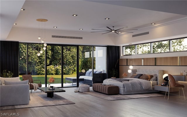 bedroom featuring multiple windows, access to exterior, and light hardwood / wood-style floors