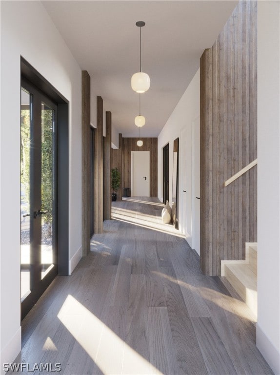 corridor with wood walls and french doors