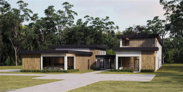 contemporary home featuring a front lawn