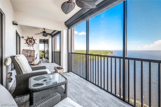 sunroom featuring ceiling fan, beamed ceiling, and a water view