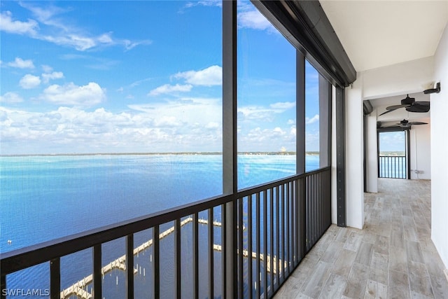 interior space with a water view and hardwood / wood-style flooring