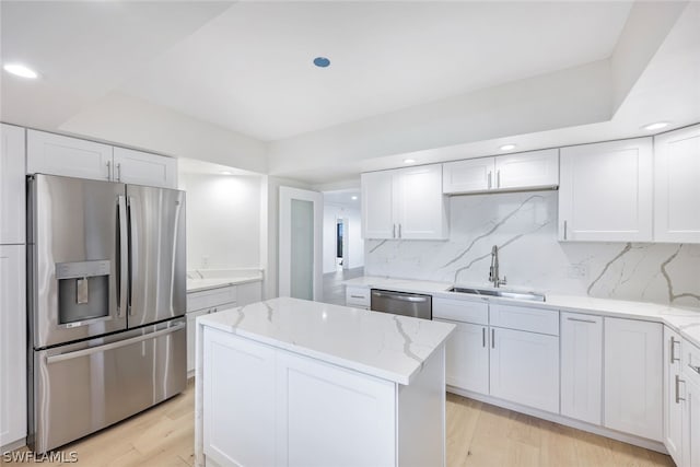 kitchen featuring light hardwood / wood-style floors, white cabinetry, sink, and appliances with stainless steel finishes