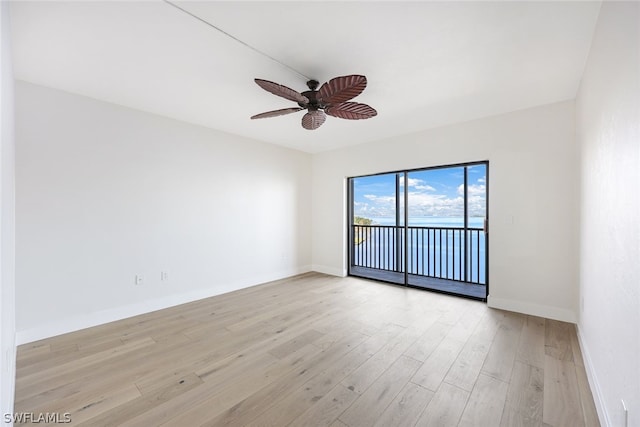 unfurnished room with ceiling fan and light hardwood / wood-style floors