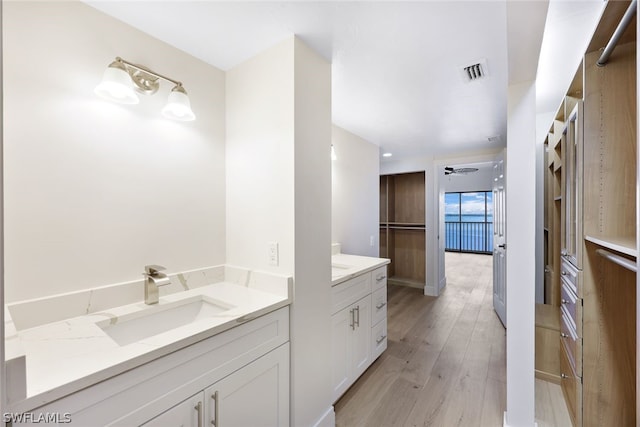 1920 Virginia Ave Unit 1502, Fort Myers, FL 33901 - full bathroom featuring two vanities and wood finished floors