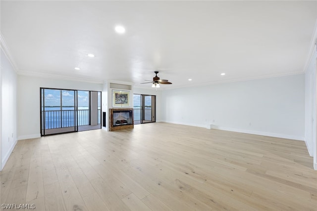 unfurnished living room featuring ceiling fan, light hardwood / wood-style floors, and crown molding