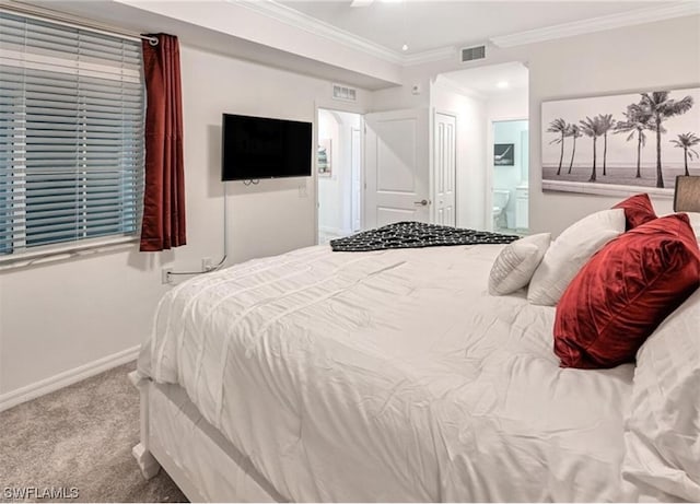 bedroom with crown molding, ensuite bath, and carpet flooring