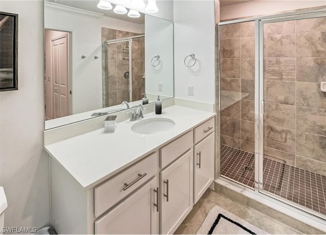 bathroom with crown molding, tile floors, vanity, and a shower with door