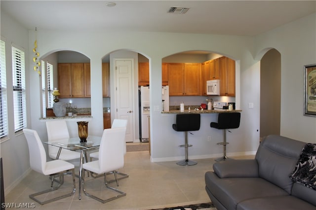 interior space with light tile flooring and a healthy amount of sunlight