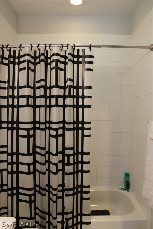 bathroom with shower / bath combo with shower curtain