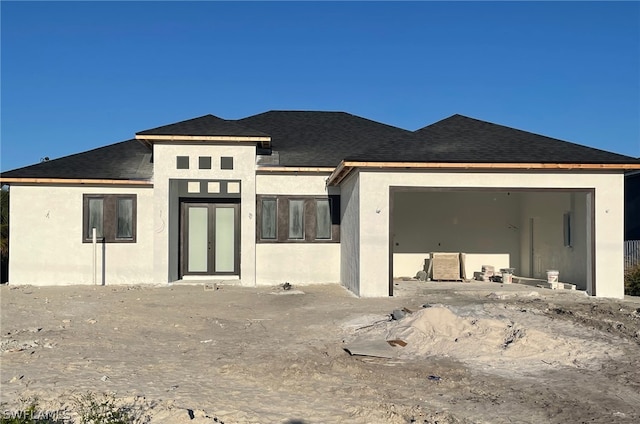 rear view of property with a garage