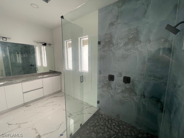 bathroom featuring tile patterned floors and a tile shower