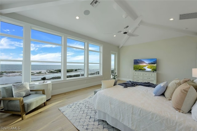 bedroom featuring ceiling fan, a water view, lofted ceiling with beams, and light hardwood / wood-style floors