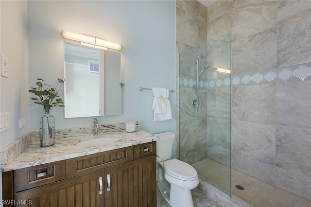 bathroom featuring an enclosed shower, vanity, and toilet