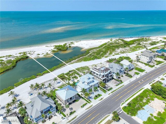 drone / aerial view with a water view and a view of the beach