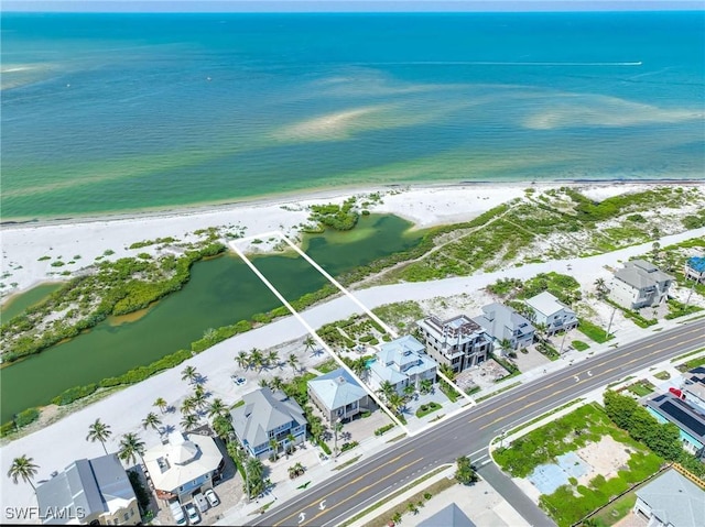 birds eye view of property featuring a beach view and a water view