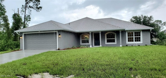 single story home featuring a garage and a front yard