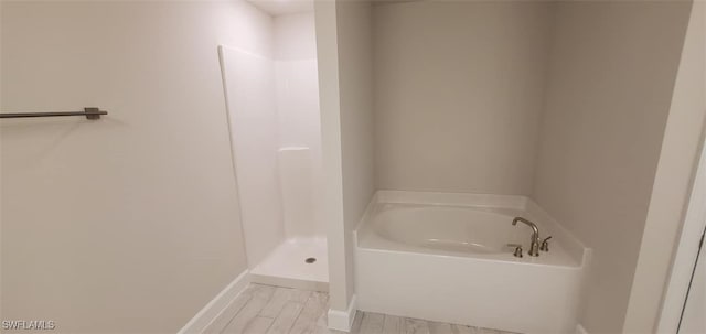 bathroom with independent shower and bath and wood-type flooring