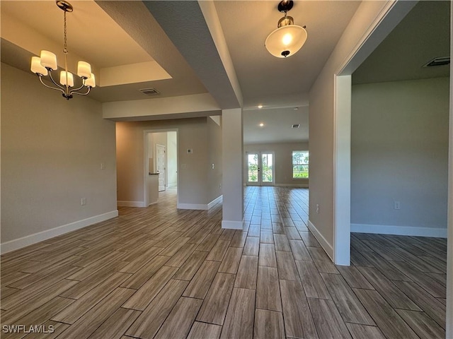 spare room featuring a notable chandelier