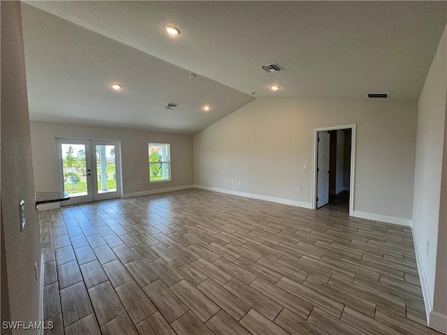 spare room featuring french doors and vaulted ceiling