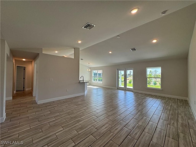 spare room with vaulted ceiling