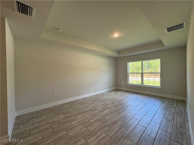 spare room featuring a raised ceiling