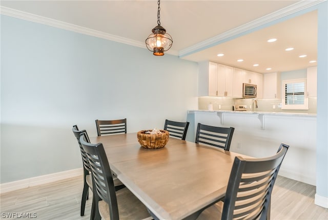 dining area featuring crown molding and sink