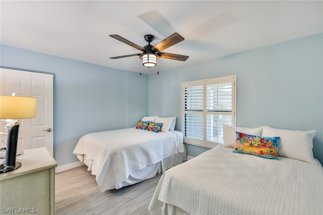 bedroom with ceiling fan and light wood-type flooring