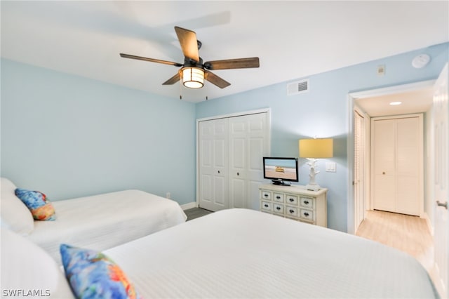 bedroom featuring a closet, ceiling fan, and light hardwood / wood-style flooring