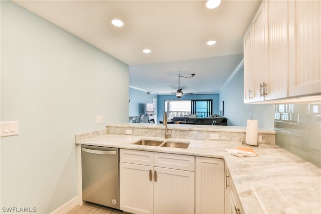 kitchen with kitchen peninsula, sink, ceiling fan, light stone counters, and dishwasher