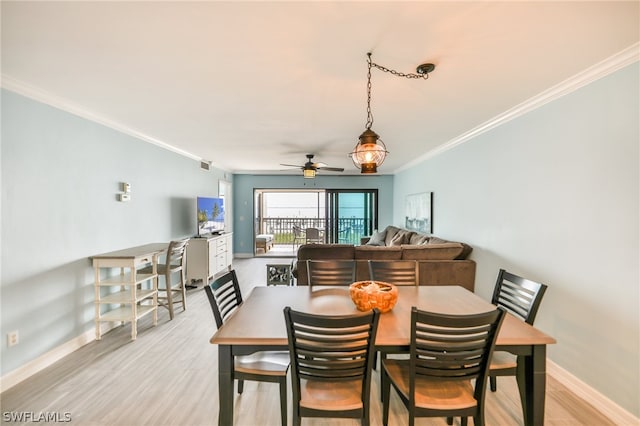 dining room with ornamental molding, ceiling fan, and light wood-type flooring