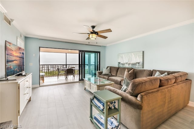 living room with ornamental molding, ceiling fan, and light hardwood / wood-style flooring