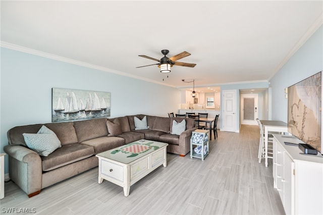 living room with ornamental molding and ceiling fan