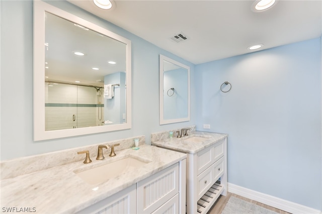 bathroom with an enclosed shower and vanity