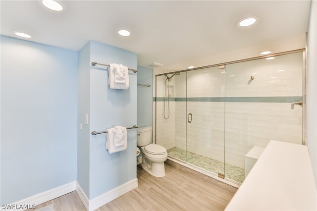 bathroom featuring walk in shower and toilet