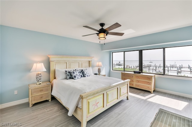 bedroom with light hardwood / wood-style floors and ceiling fan