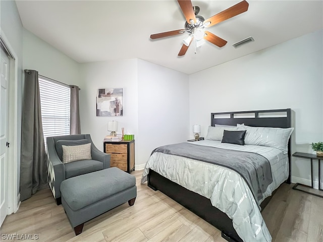 bedroom featuring a closet, light hardwood / wood-style floors, and ceiling fan