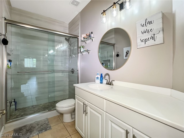 bathroom featuring oversized vanity, toilet, tile floors, and a shower with door