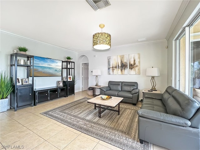 living room featuring ornamental molding and light tile floors