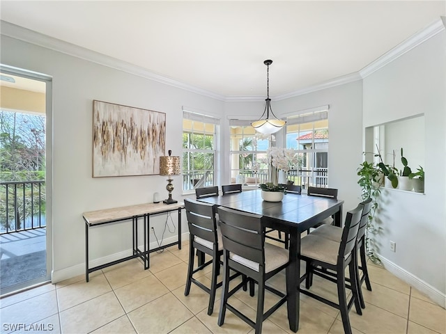 dining room featuring ornamental molding and light tile floors