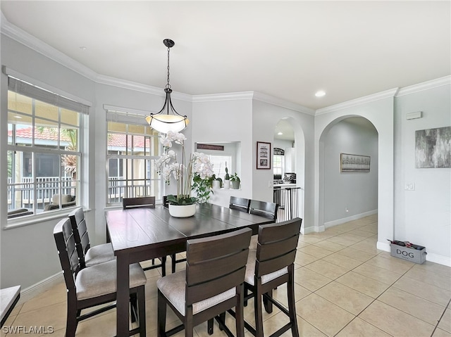 dining space featuring light tile flooring and ornamental molding