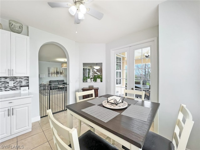 dining room featuring light tile floors, french doors, and ceiling fan