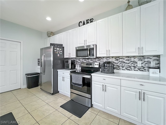 kitchen featuring light tile floors, white cabinetry, tasteful backsplash, and stainless steel appliances