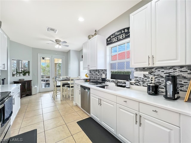 kitchen with ceiling fan, tasteful backsplash, appliances with stainless steel finishes, white cabinetry, and sink