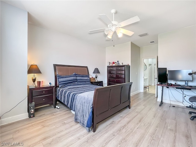 bedroom with ceiling fan, ensuite bath, and light hardwood / wood-style flooring