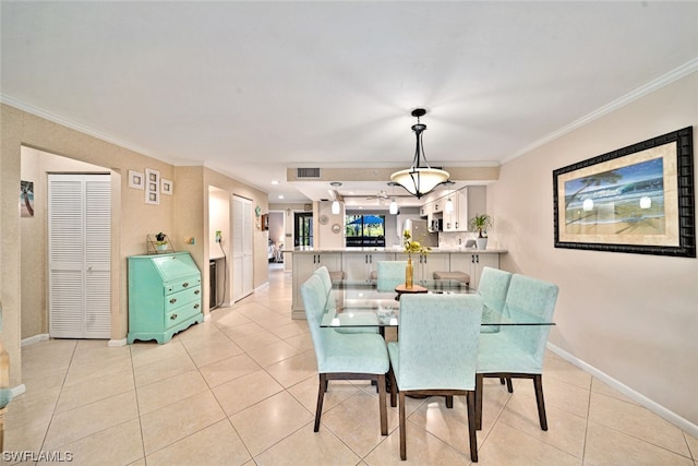 dining space featuring light tile patterned floors and crown molding