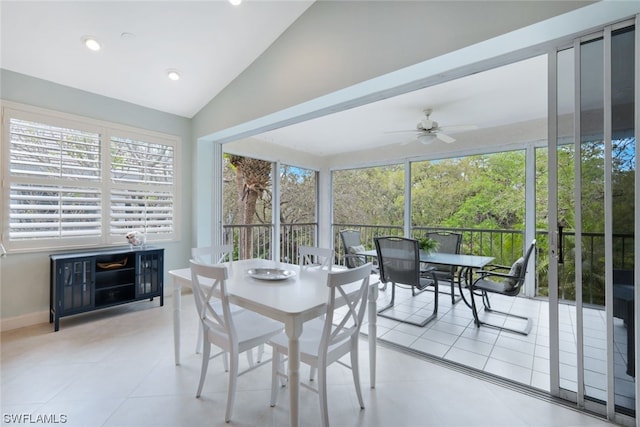 tiled dining space featuring vaulted ceiling, ceiling fan, and plenty of natural light