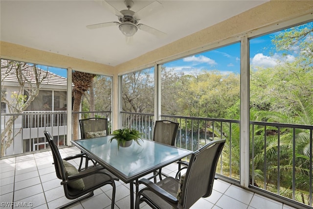 unfurnished sunroom with ceiling fan