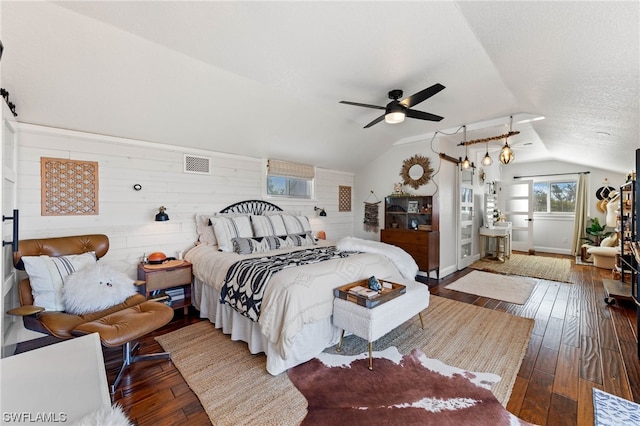 bedroom featuring wood-type flooring, vaulted ceiling, ceiling fan, and wood walls